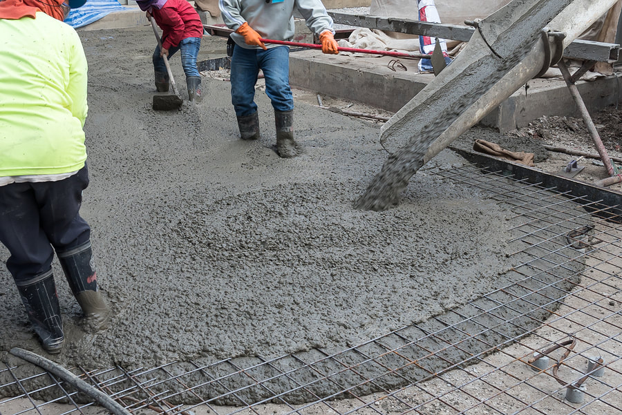 construction workers pouring cement